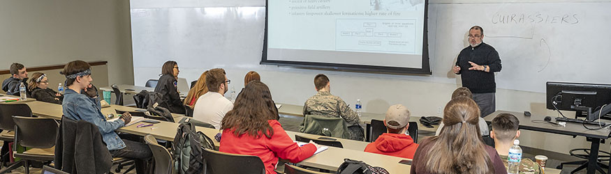 photo of students and a professor in a classroom