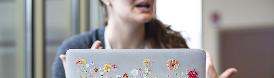 photo of a person sitting in front of a laptop