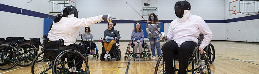 photo of students in a wheelchair fencing class