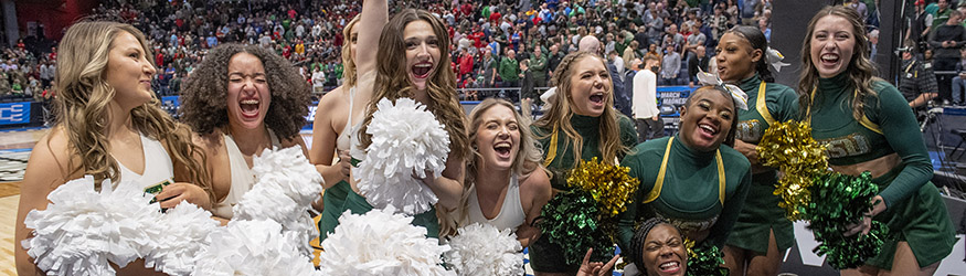 photo of cheerleaders and dancers at a basketball game