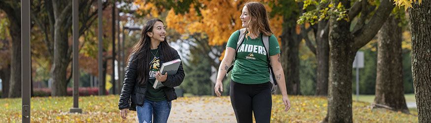 photo of two students walking outside on campus