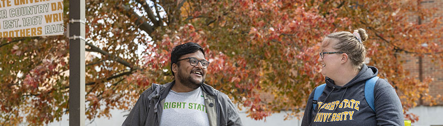 photo of two students walking outside on campus