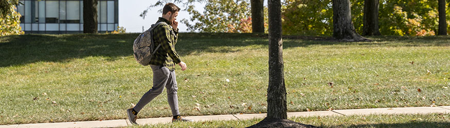 photo of a student walking on campus