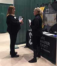 Photo from Career Fair 2018 Spring Semester, featuring a student talking to recruiter from Clark Schaefer Hackett..