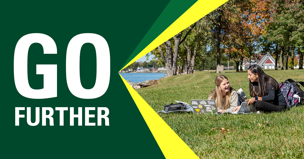 Students sitting on Lake Campus lawn with lake in background