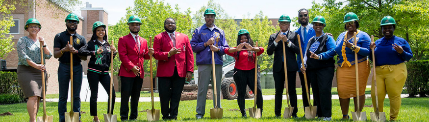 Photo of NPHC students and President Edwards at NPHC plot groundbreaking