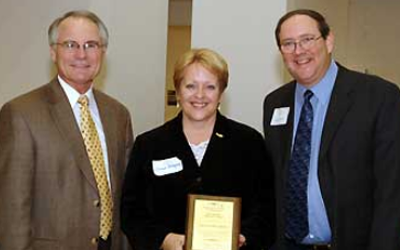 Political Science professor Donna Schlagheck with Provost David Hopkins, left, and Douglas Nord, Director of the University Cent