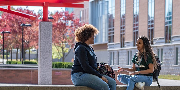 Students sitting and talking on campus