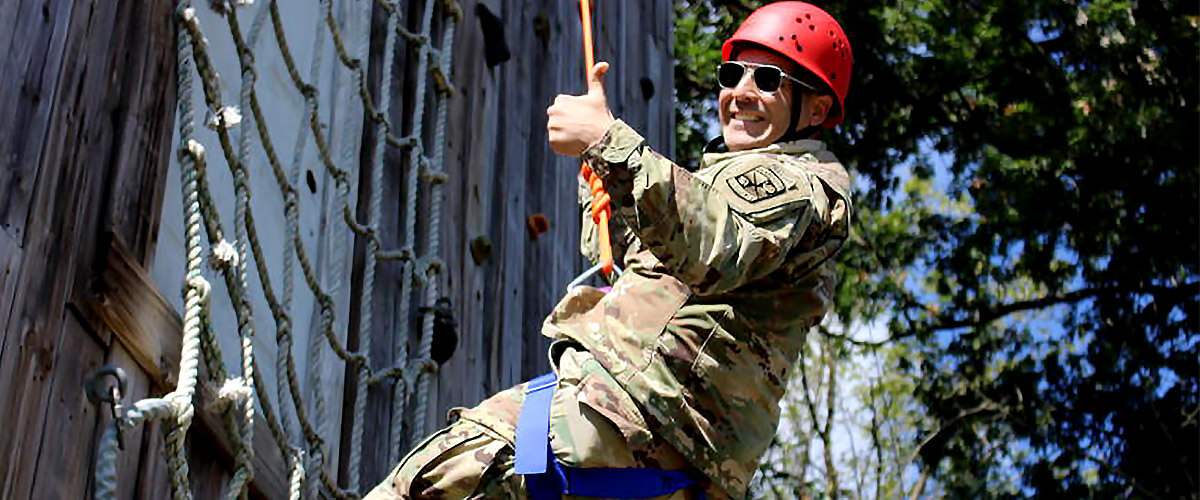 Army Rotc Student climbing a wall on campus