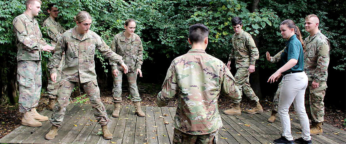 Army Rotc students problem together solving out side in the woods