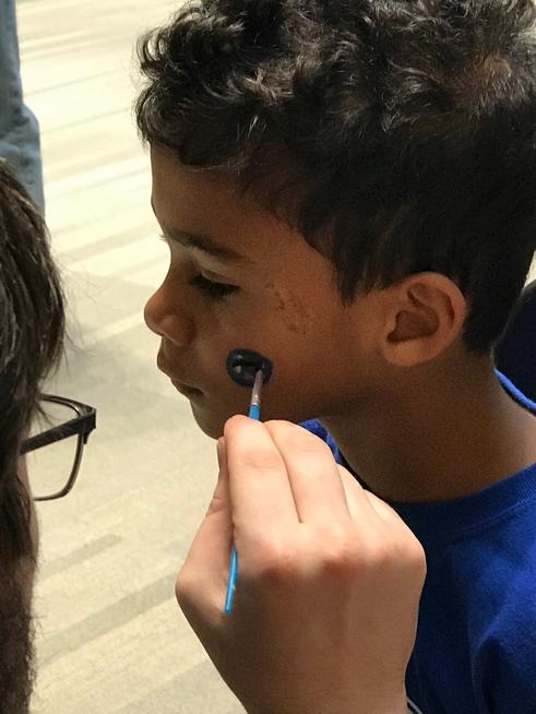 Child's face being painted