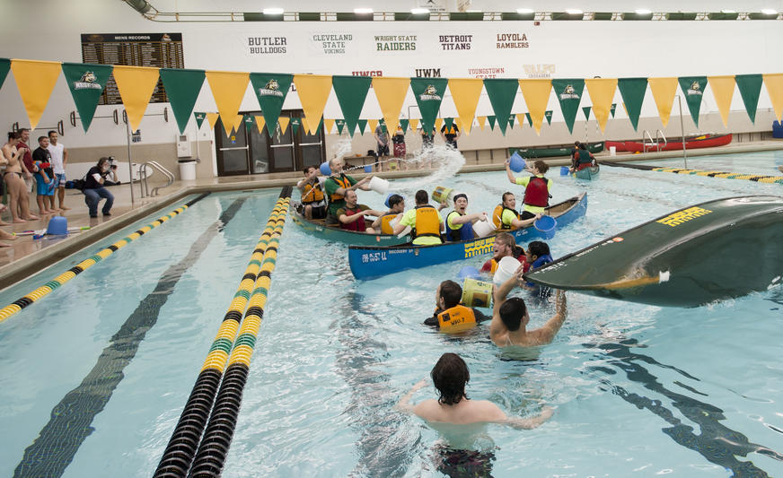 photo of students in boats in the pool