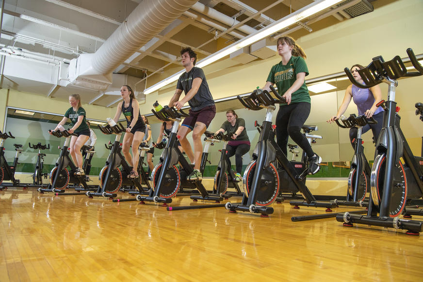 photo of people cycling in a group fitness room