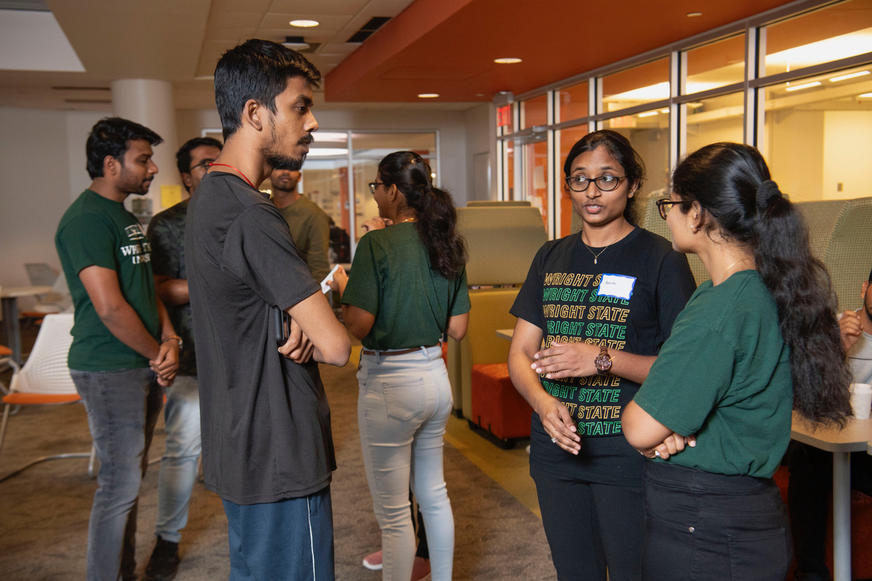 photo of students talking at a meet and greet event