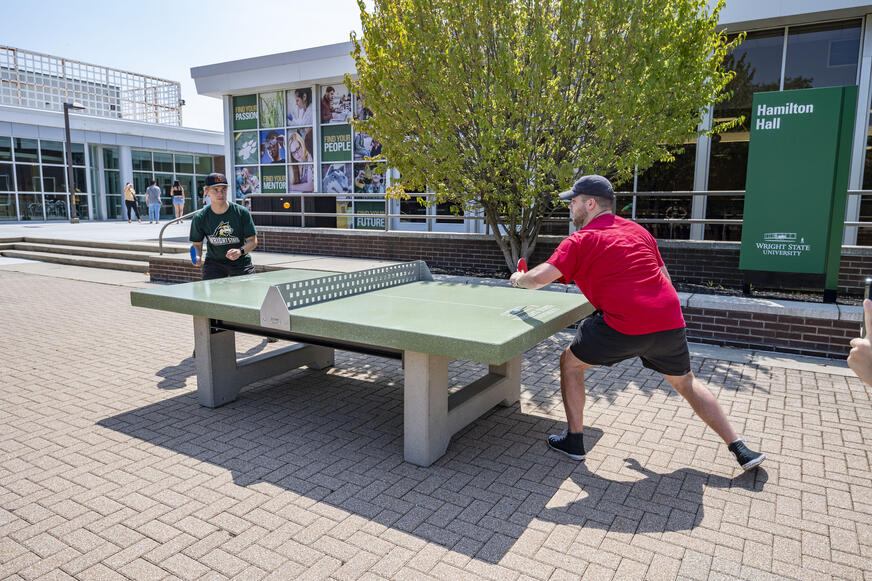 photo of students playing table tennis on campus