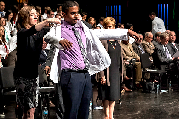 Incoming medical students receive white coats at convocation
