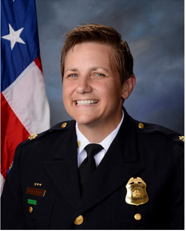 Picture of Major Wendy Stiver in Police uniform with American flag over right shoulder