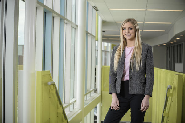 Student stands in business attire at Wright State