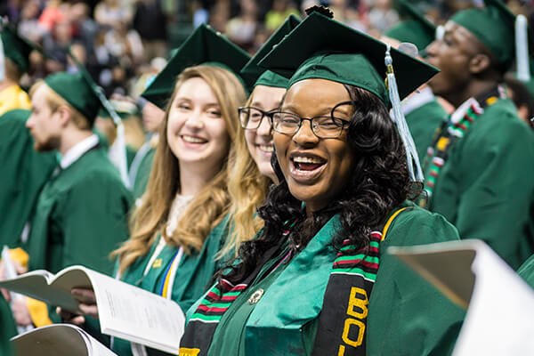 Women smiling at their commencement 