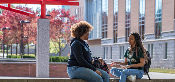 Students standing and smiling on campus