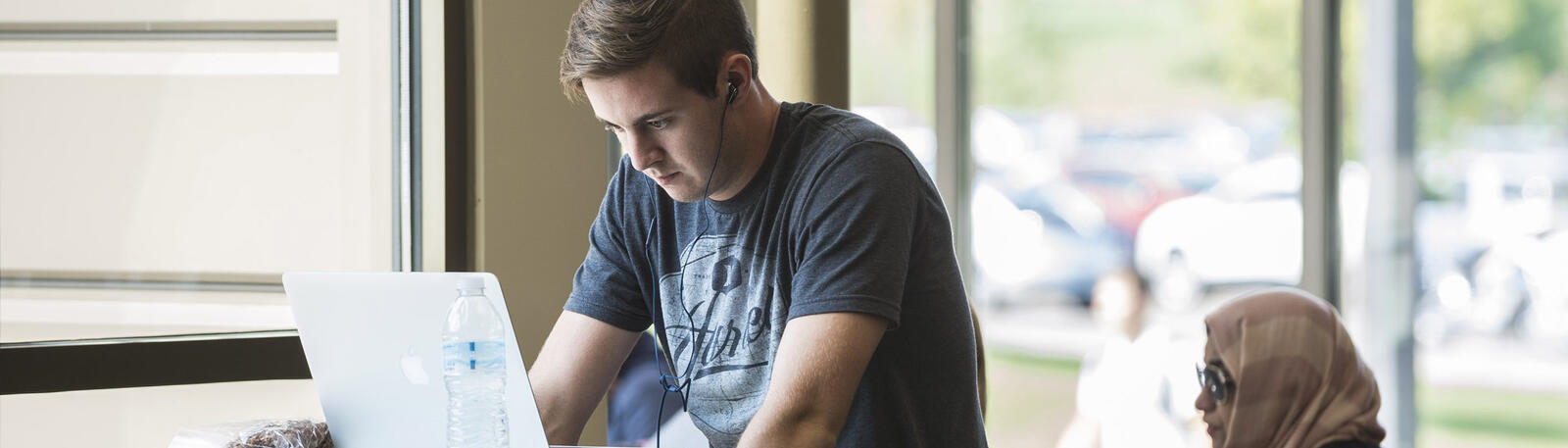 photo of a student looking at a laptop