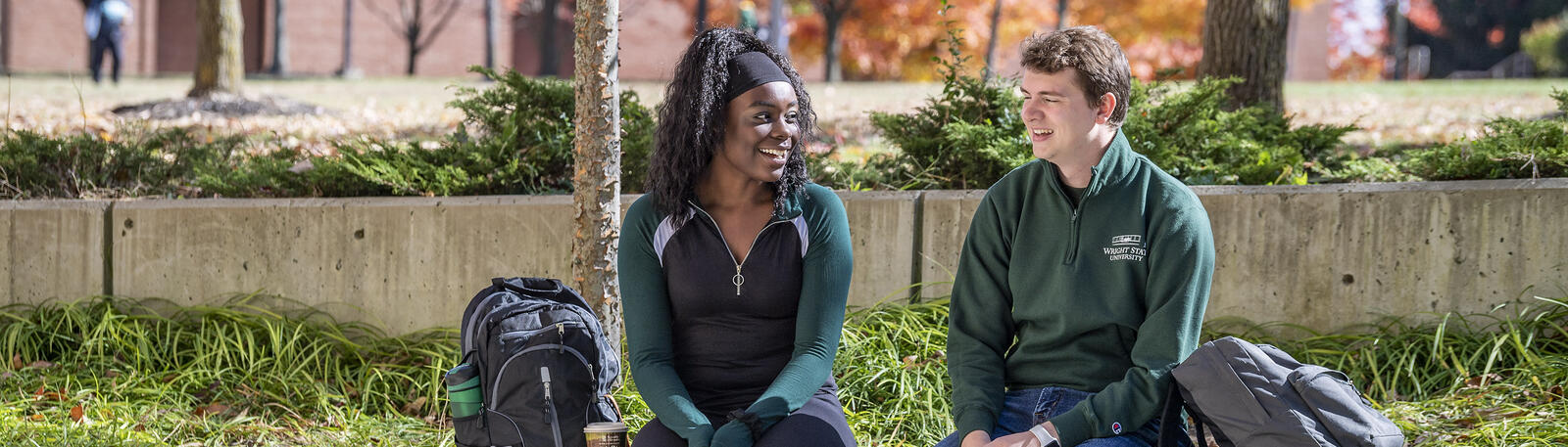 photo of students sitting outside on campus