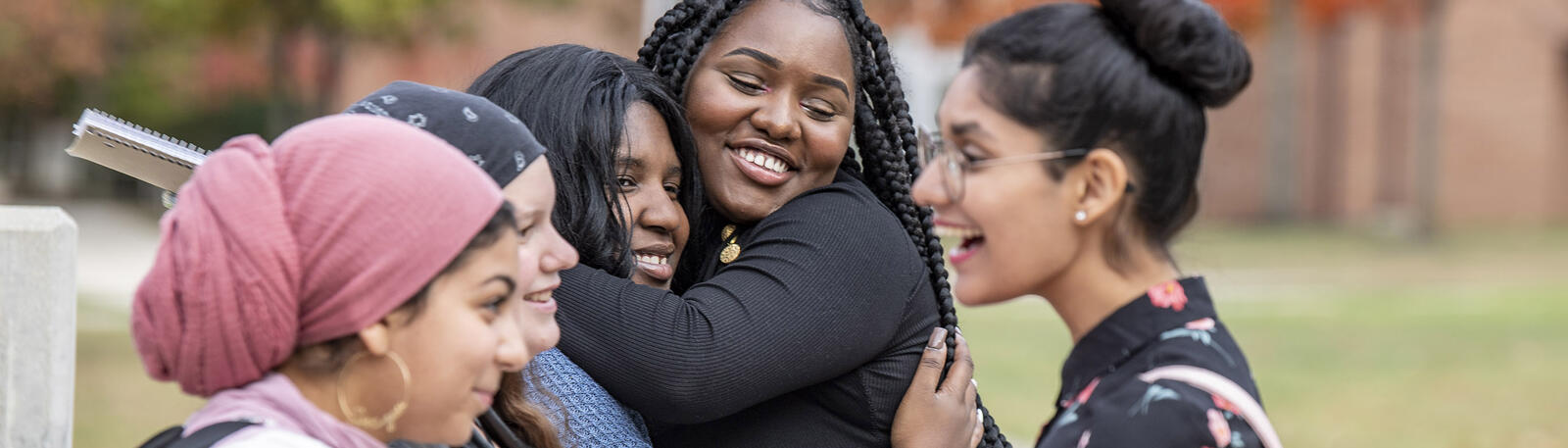 photo of students sitting outside on campus