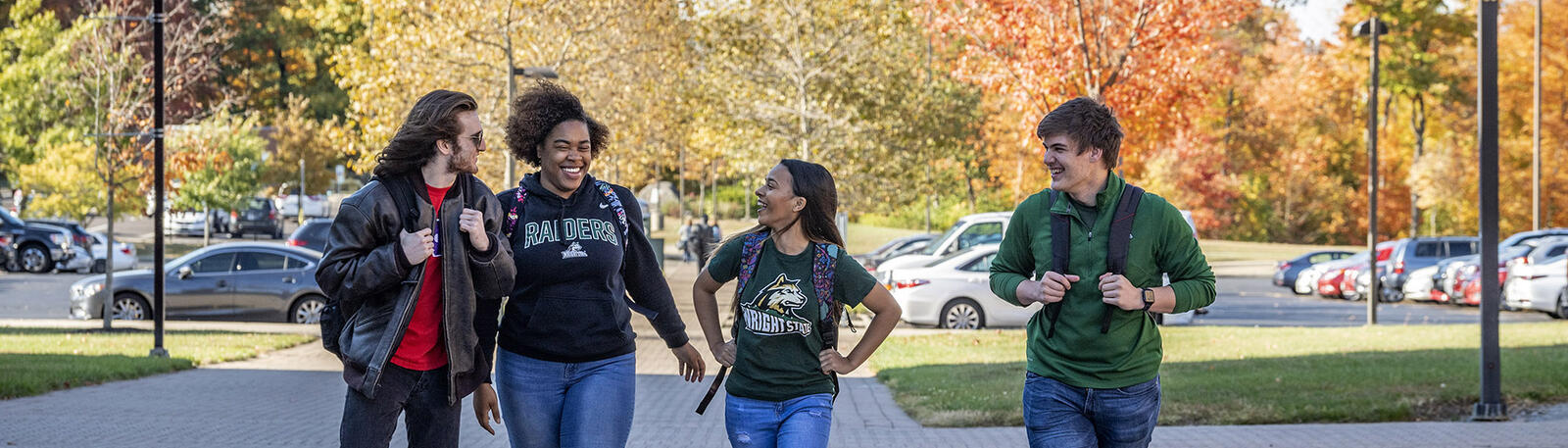 photo of students walking and talking on campus