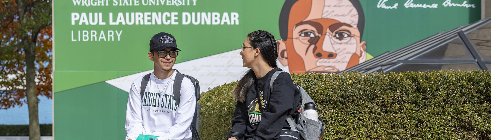 photo of students sitting outside on campus