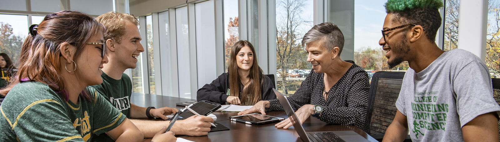 photo of students and an instructor at a table in the student success center