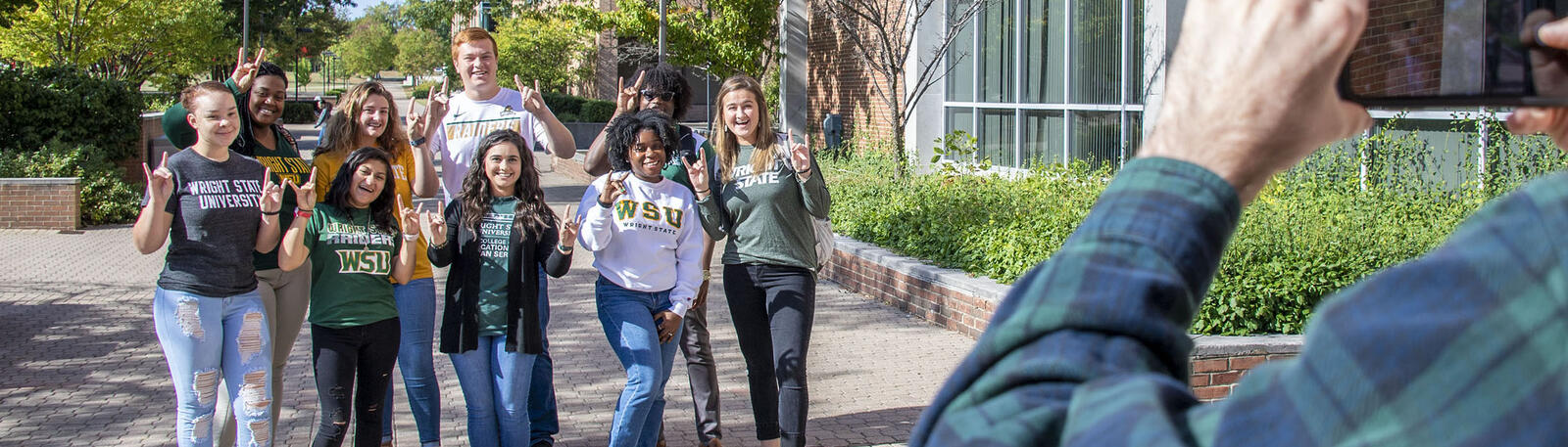 photo of students posing for a group photo on campus
