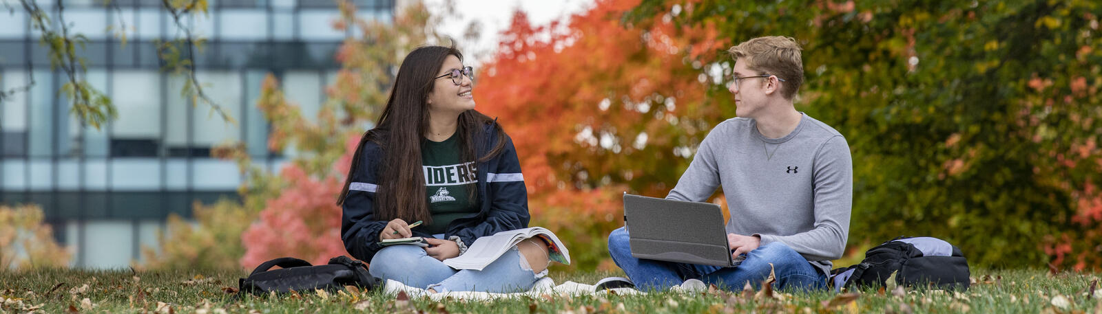photo of students sitting outside on campus