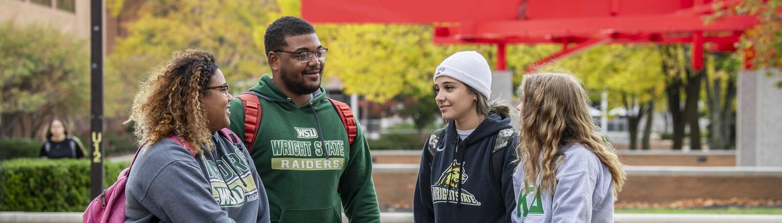 photo of students sitting outside on campus