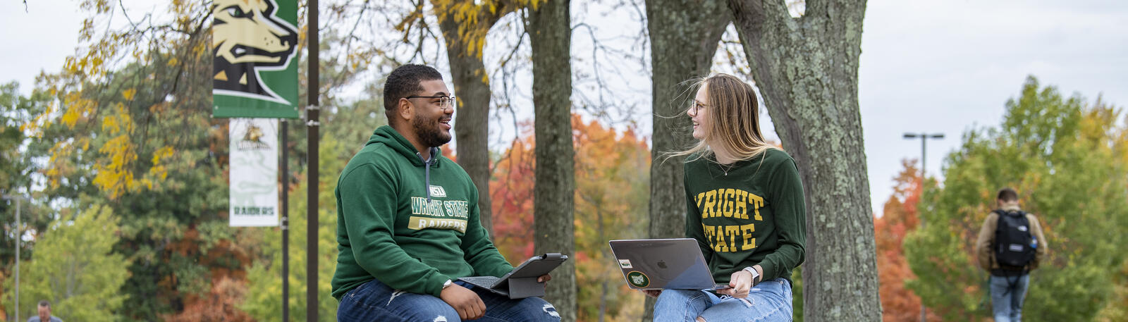 photo of students sitting outside on campus