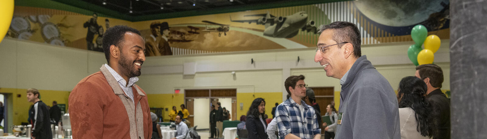 photo of a student and staff member at an open house