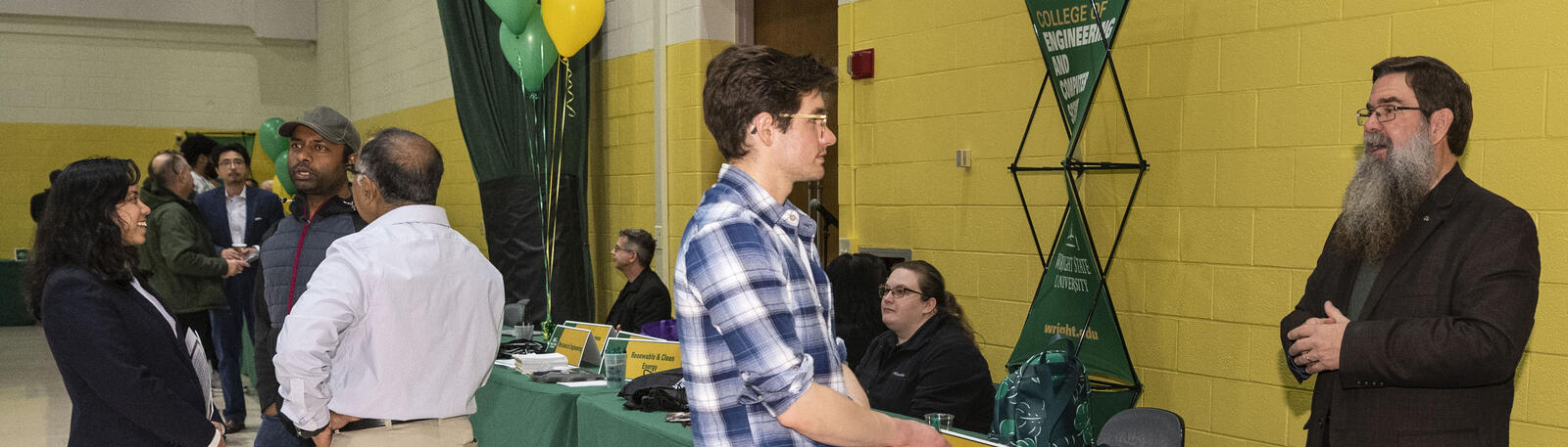 photo of students and staff at an open house