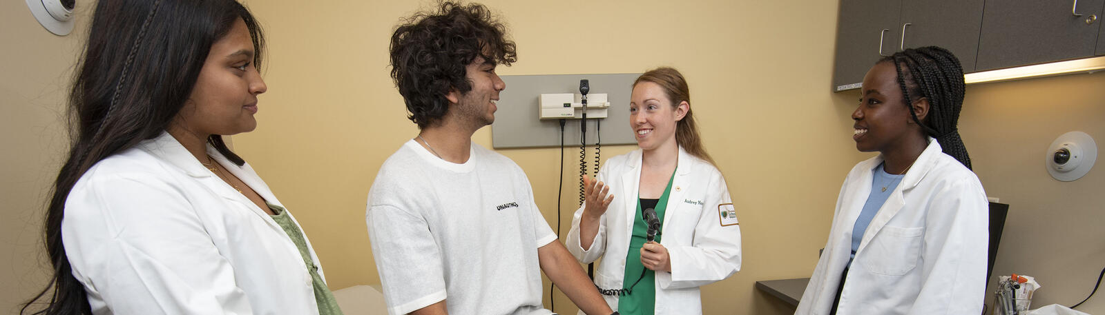 photo of students and an instructor with a mock patient