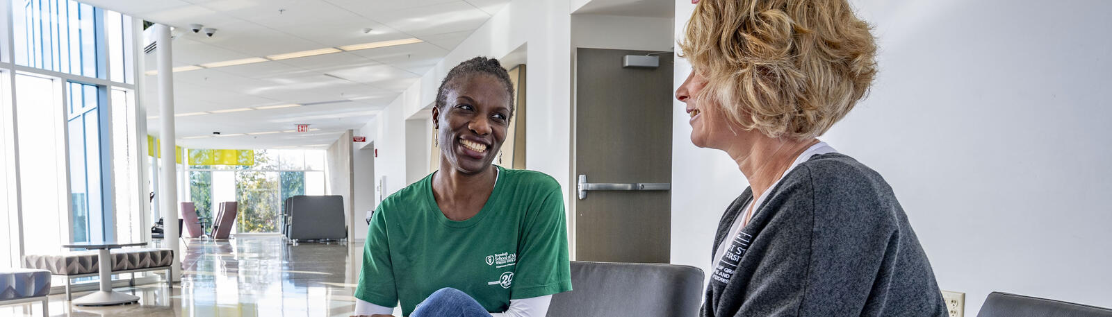 photo of a student and staff member talking