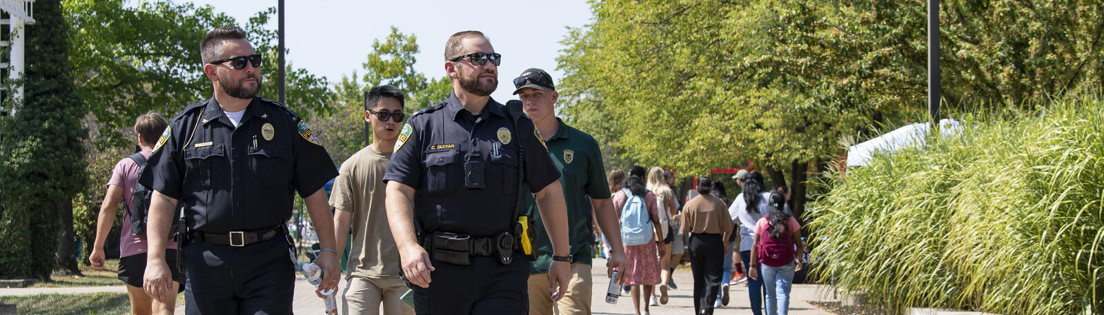 photo of officers and students walking on campus