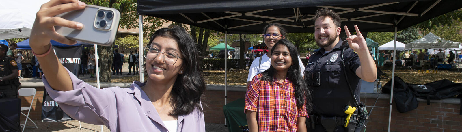 photo of students and officers at an event on campus