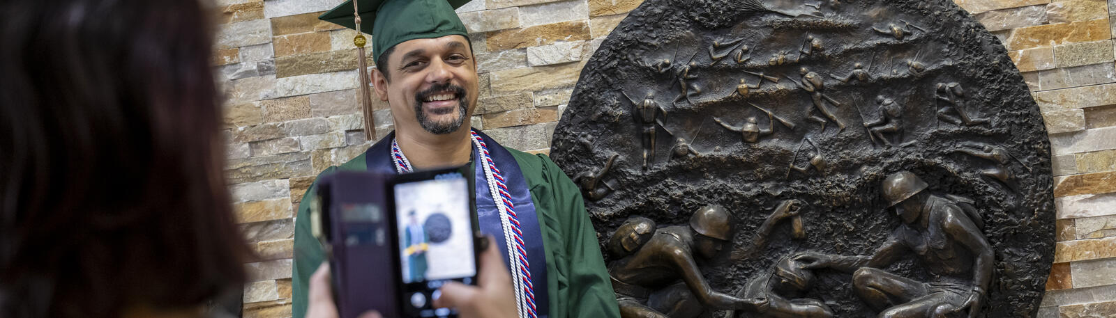 photo of a graduate posing for a photo