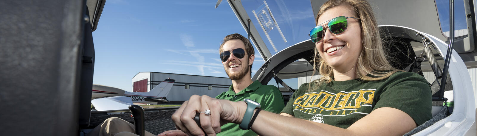 student and instructor sitting in a plane