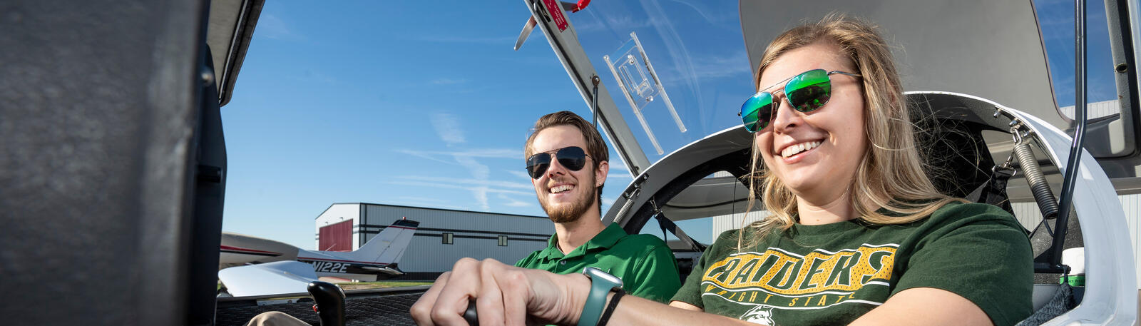 student and instructor sitting in a plane