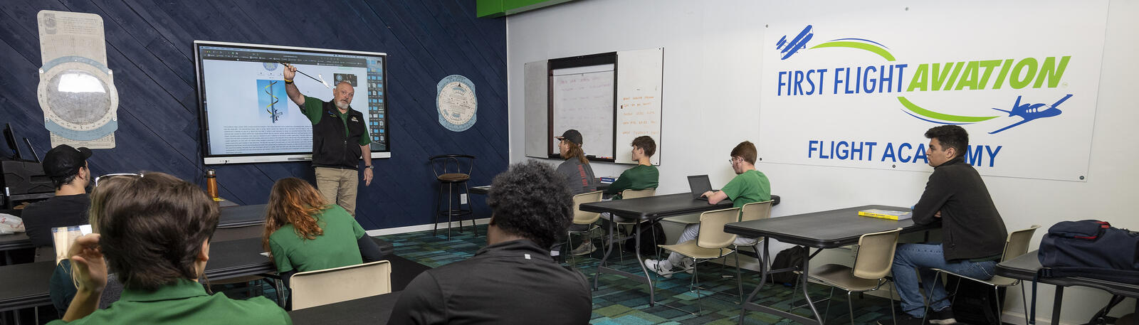 students and an instructor in an aviation classroom