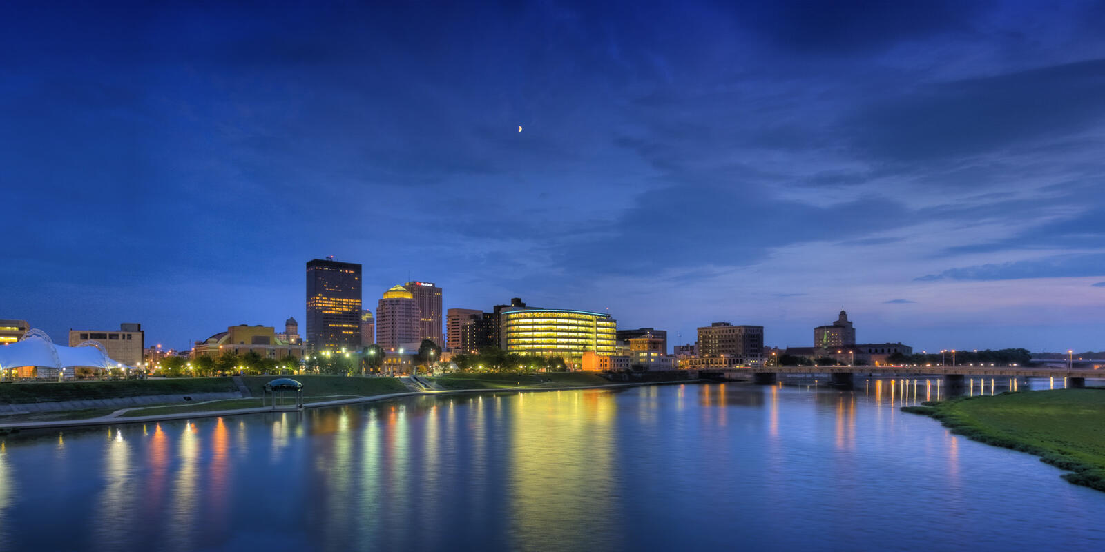 Panorama of Downtown Dayton skyline at twilight, looking across the Great Miami River near RiverScape MetroPark