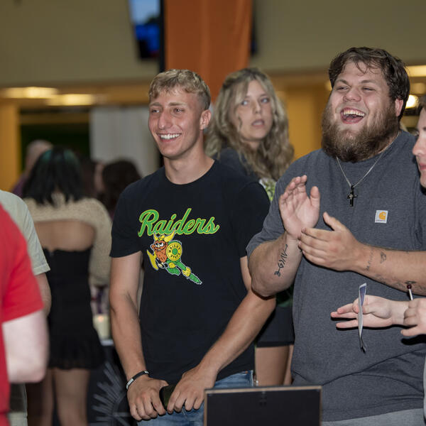 students laughing at an event in the student union
