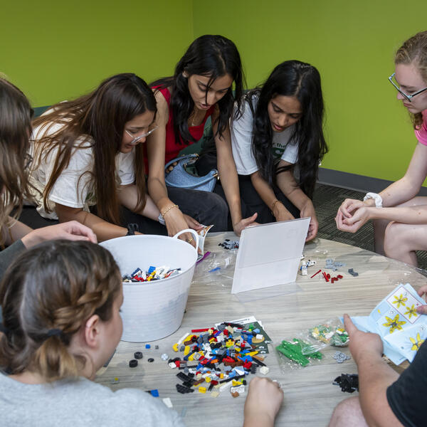 students assembling a lego project at a table at a campus event