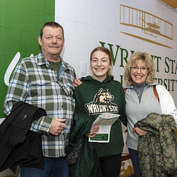 a student and parents posing for a photo in the student union at wright state