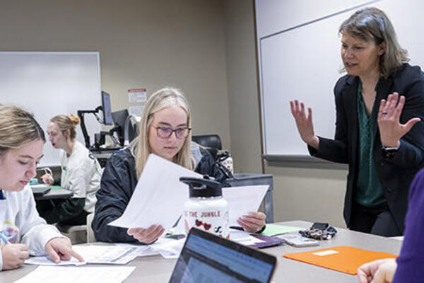 photo of students and a professor in a class
