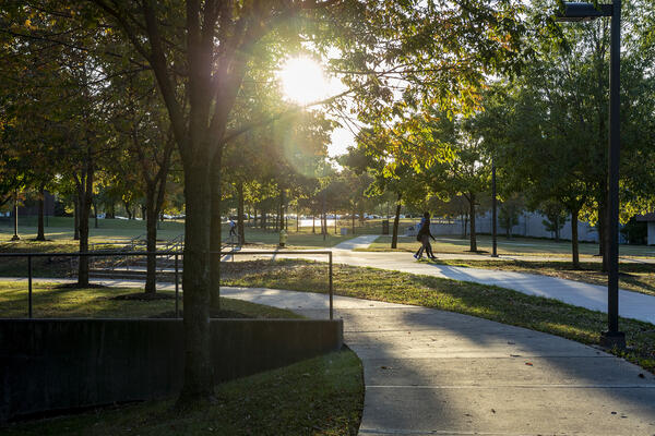 people walking on campus as the sun rises